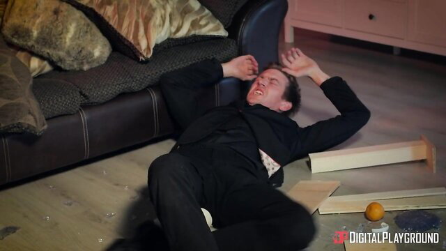 Danny D in suit sprawled on floor in fierce clash scene