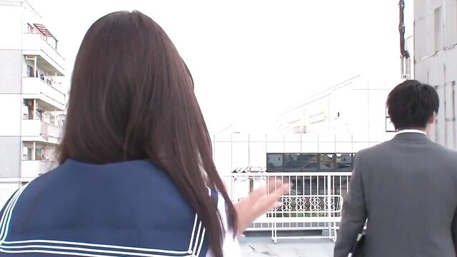 Mayu Yukii in sailor uniform reaching out to suited man JAV scene