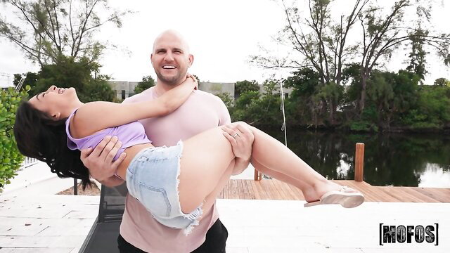 Johnny Love holds up busty Latina in tiny shorts on Mofos dock