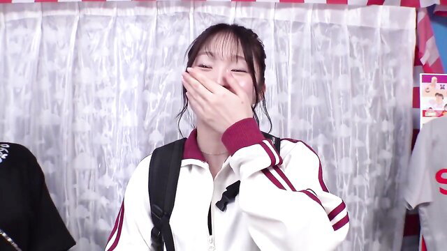 Cute Japanese teen girl in tracksuit covering mouth laughing in JAV magic mirror