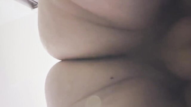 Uncensored closeup of woman's huge pale tits pressed together, face revealed