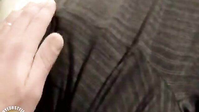 Hand groping sleeping girl's nude body under striped sheet