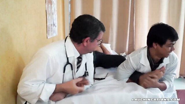 Two Asian male doctors tickling patient in hospital bed fetish scene