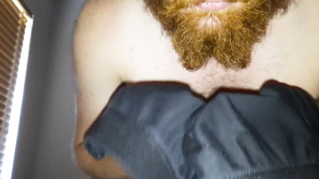 Bearded man nuzzling black panties closeup in erotic tease