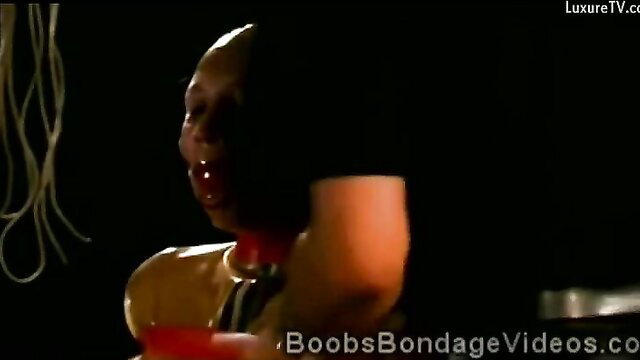 Hot bitch in latex outfit with tied up boobs and clamped nipples