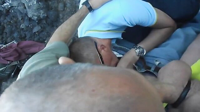 Bald daddy facefucks twink outdoors on Algarve rocks