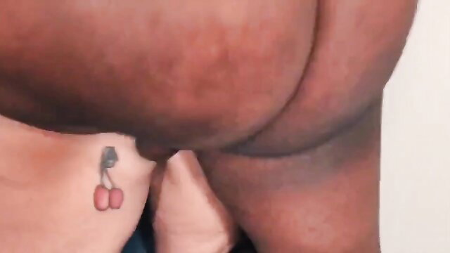 Curvy black cougar's big ass with cherry tattoo in teasing interracial tease