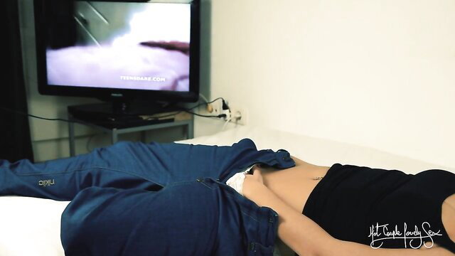 Hot Asian MILF exposes pussy masturbating to lesbian porn on TV