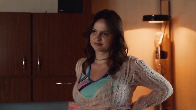 Woman posing in a bedroom with hand on hip