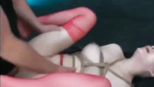 Bound Asian babe in red ropes spread legs for rough play