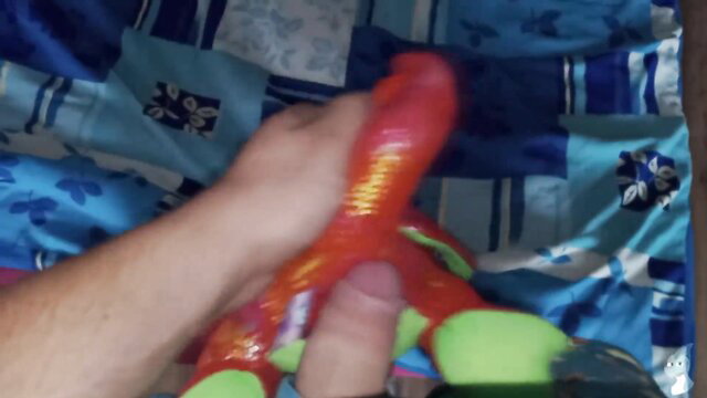 Hand stroking glossy red dragon dildo closeup in amateur solo toy play