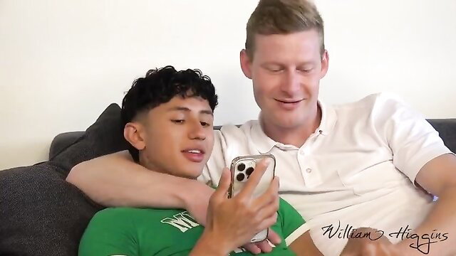 Cute Asian twink hugged by fit white daddy on sofa, gay tease