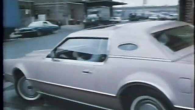 Vintage 1980s pink coupe car parked in urban lot, Girls U.S.A. porn