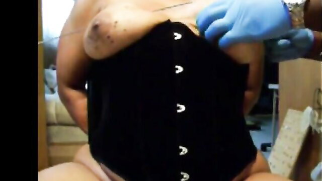 Busty woman screams as gloved hands shove needles into her huge tits