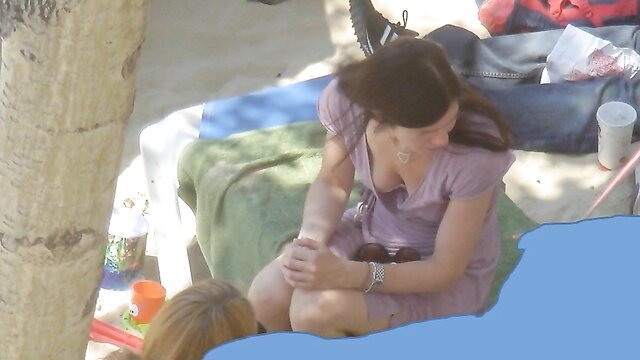 Two irresistible gals in dresses sunbathing on beach towels