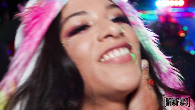 Hot latina babe with pink fluffy hair smiling at neon silent disco party
