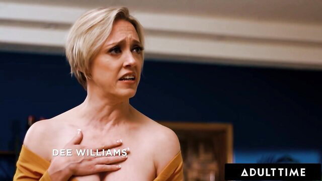 Dee Williams off-shoulder, touching her chest