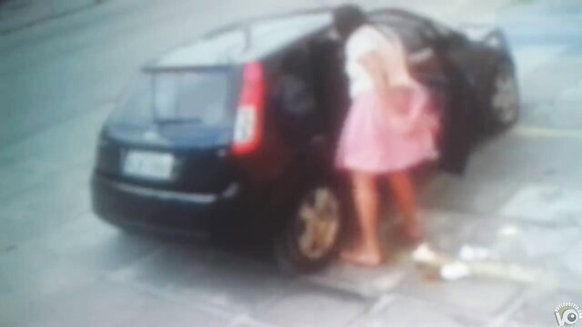 Blurry amateur girl in pink skirt bending over car for quick poop