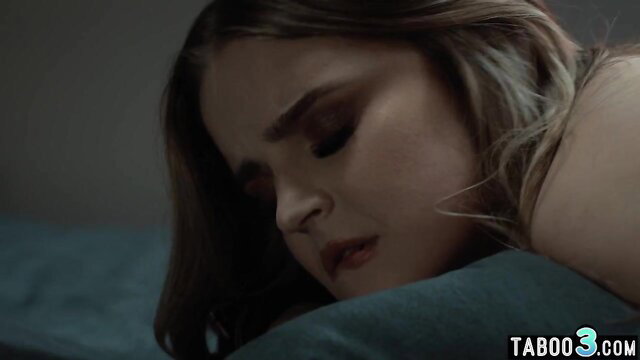 Closeup of busty blonde BBW with sultry eyes in bed, lesbian tease