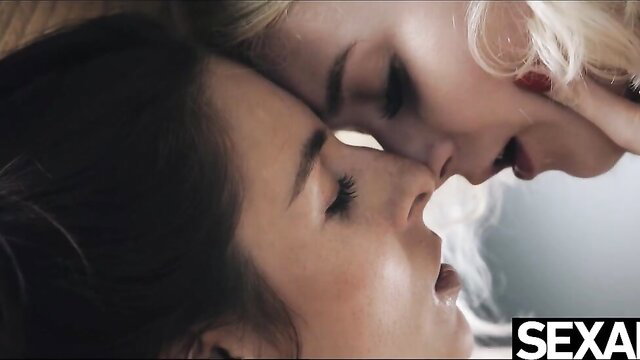 Cute blonde nuzzles girlfriend's big natural tits intimately