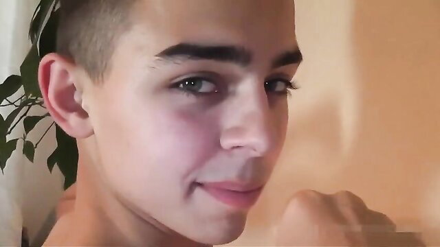 Handsome 19yo twink with shaved pubis smiles close-up
