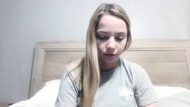 Nikki Vixen babyfaced blonde in grey tee on bed, amateur solo tease