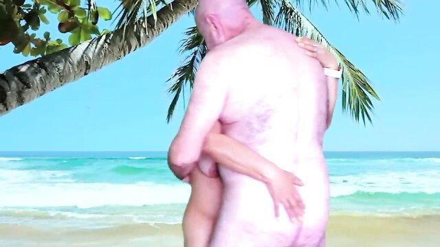 Bald older man hugs nude woman on sunny beach embrace preview