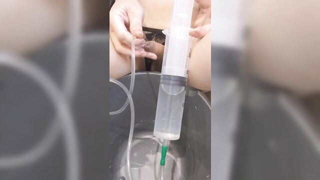 Tafina transgirl fills enema syringe for urethral clyster play