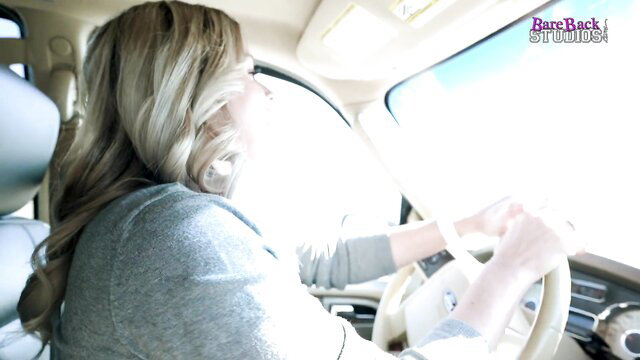 Busty blonde Coco Vandi driving in car on vacation