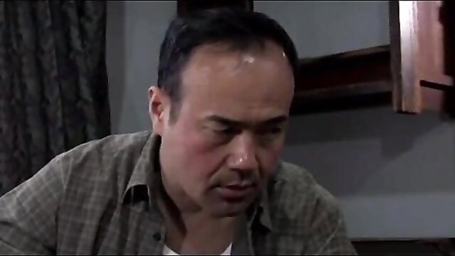 Japanese man in plaid shirt gazes intently, JAV husband-wife friend scene thumbnail