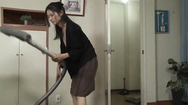 Asian office lady in skirt bends over vacuuming, upskirt tease
