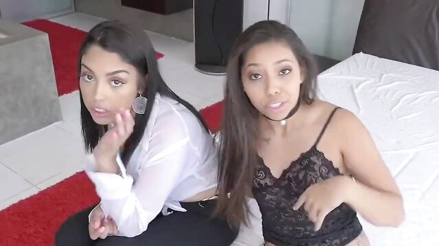 Sexy Latina sisters in lingerie posing seductively on bed