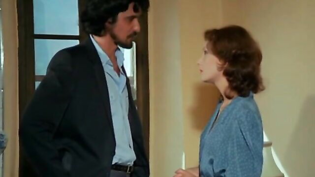 Vintage 1981 French couple: hairy man in suit chats up brunette prof