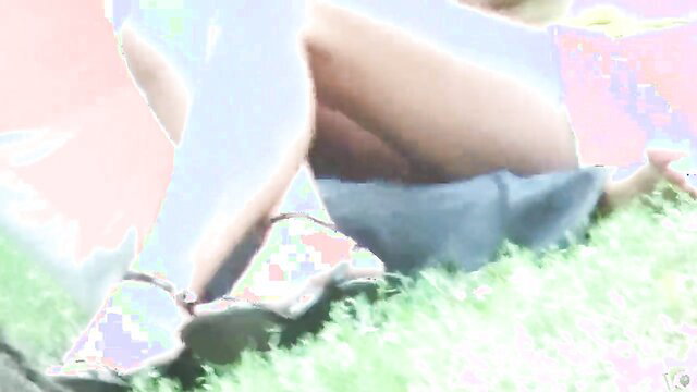 Blonde woman sitting on grass without panties