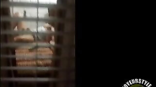 Voyeur cam peeks through bars at nude solo girl's big tits & ass