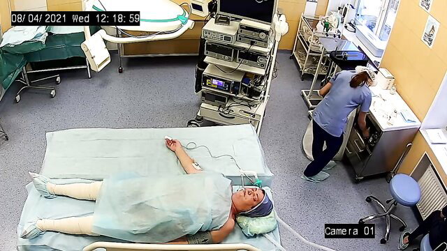Sedated mature woman log rolled, prepped naked for surgery