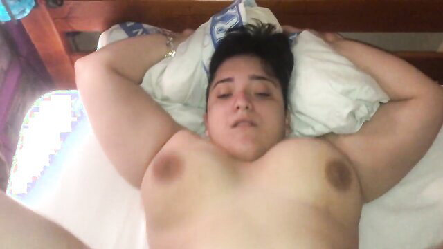 Hotwheels lying nude on bed, arms up, big tits exposed in hot thumbnail