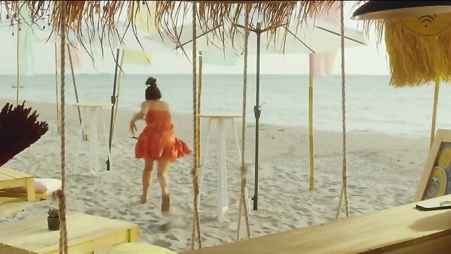 Christine Bermas running on beach in sexy orange dress Hilom 2023