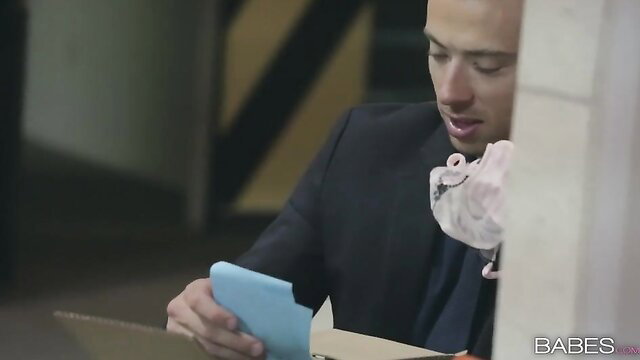 Handsome suited man in office holds pink toy and blue phone, naughty vibe