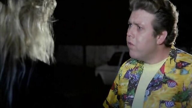 Vintage 1990s German softcore: busty blonde teases chubby guy in loud Hawaiian shirt