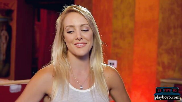 Blonde bombshell in tight white tank top on femdom comedy show