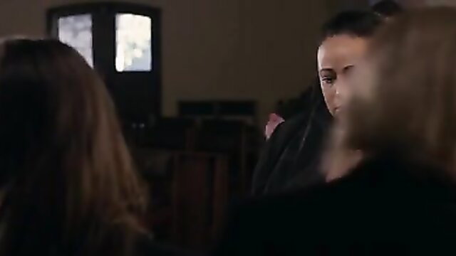 Brunette woman in dark dress at mysterious adult gathering