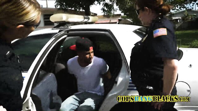 Hot white female cop cuffs resistant black criminal in patrol car