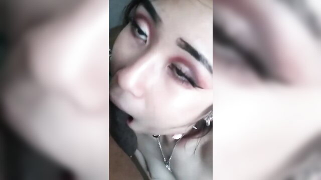 Petite Asian closeup with sultry smokey eyes and glossy lips