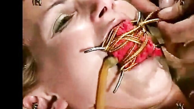 Busty blonde Wenona gagged with red cloth and wires in bondage