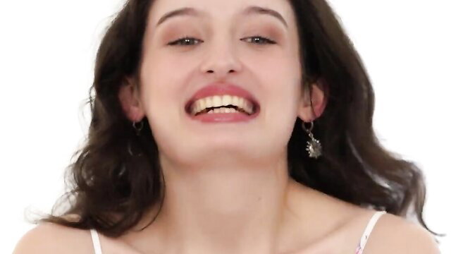 Young beautiful Thalia smiling sensually in white camisole