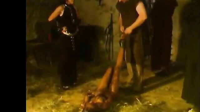 Nude woman impaled on pole by dominatrix in extreme fetish scene