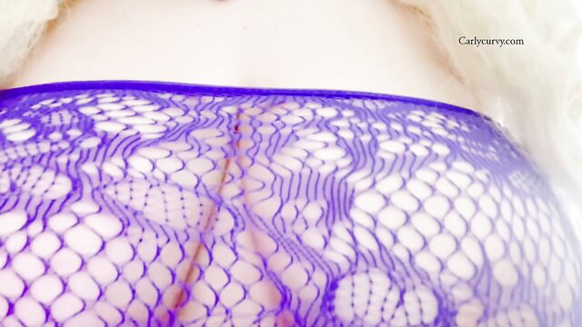 Closeup of woman's big ass in sheer purple lace lingerie thong