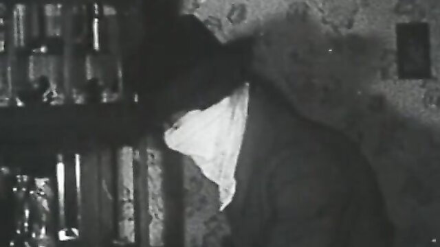 Vintage French stag film The Thief: masked man at bar in classic black & white XXX