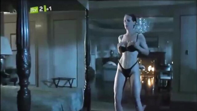 Tall brunette bombshell in black lingerie striking sexy pose